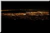 8:47 PM. The dark patch below the thin strip of lights on top is the bay.  The strip of lights is the west bay, i.e. the penisula