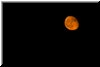 9:13 PM.  The moon finally rises from the east. Like the sunrise, the moon rises with a warm reddish tone.